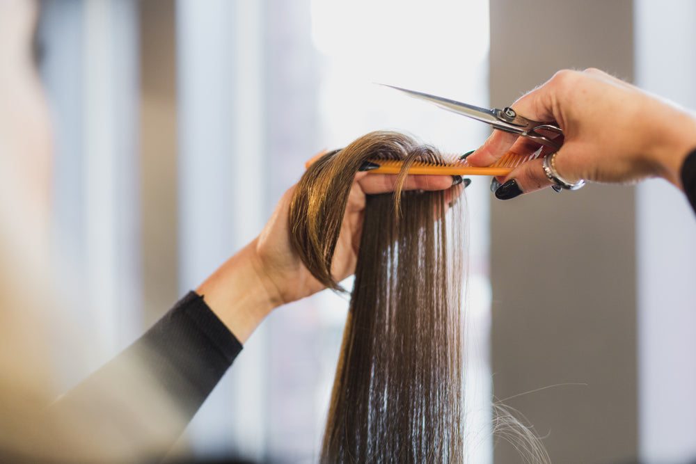 hands trimming long hair