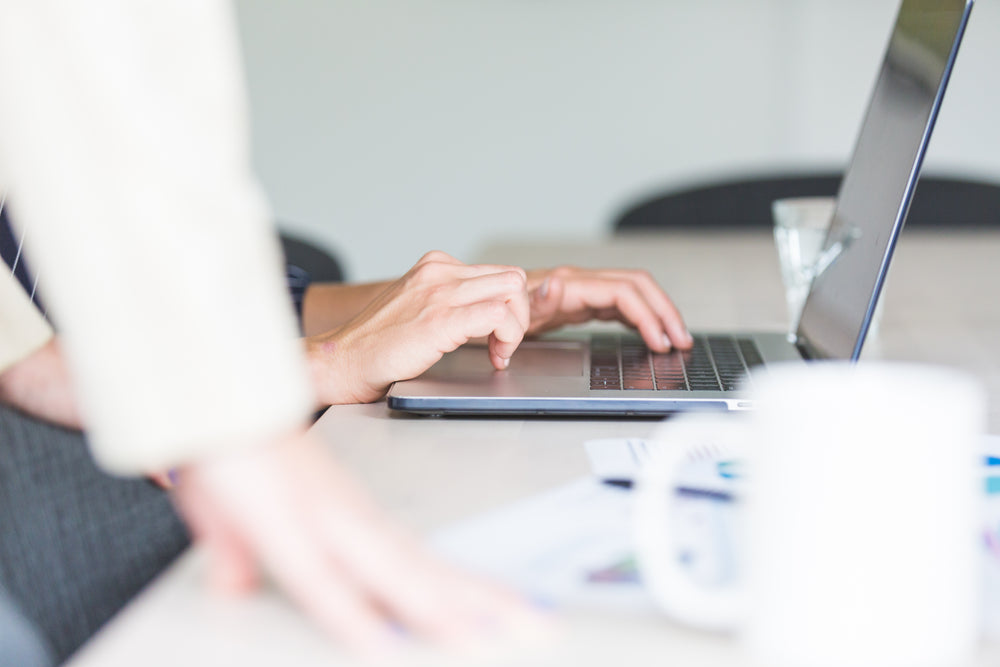 hands using computer in office