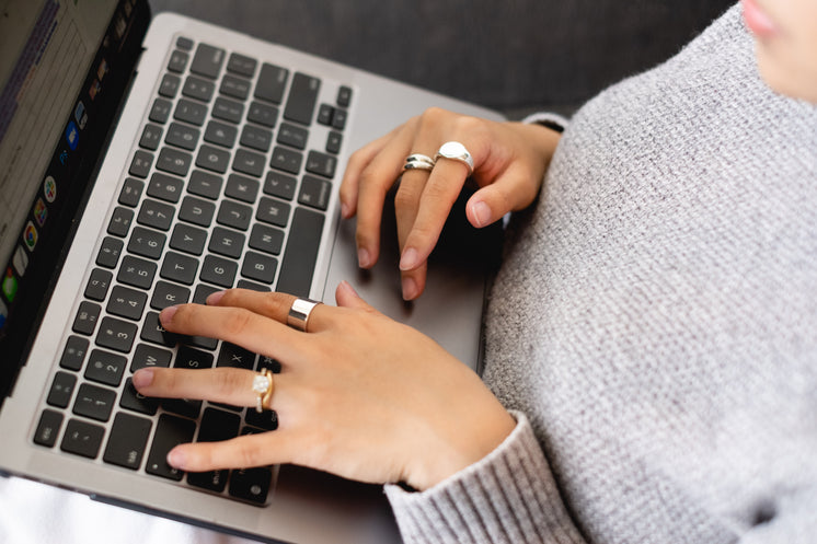 hands-with-gold-rings-type-on-a-laptop.j