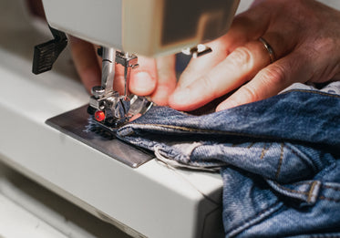 hands working with denim material