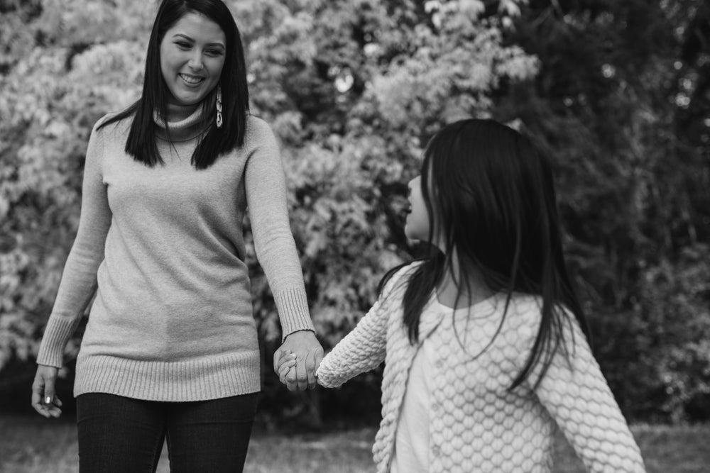 happy child and woman holding hands