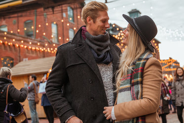 High Res Happy Couple Under Holiday Lights Picture — Free Images