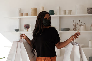 happy customer holds five shopping bags