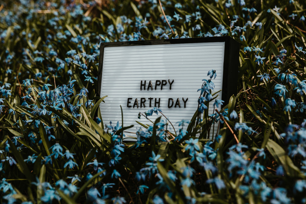 happy earth day sign in flowers