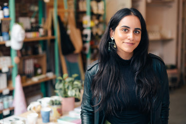 happy entrepreneur standing in her store