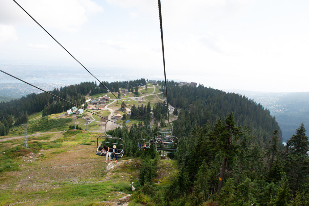 happy tourists on a chairlift in the mountains