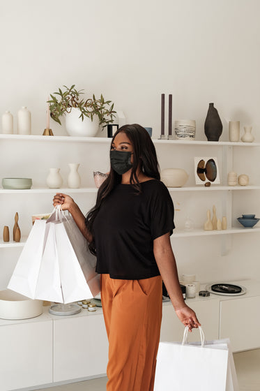 happy woman and shopping bags in store