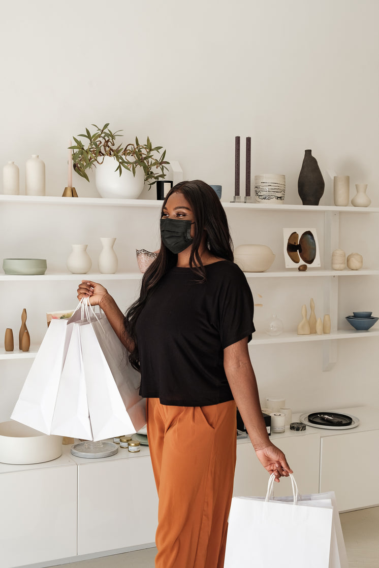 Happy Woman And Shopping Bags In Store