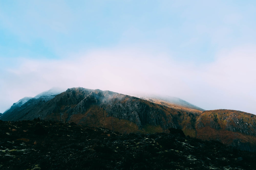 hazy clouds settle on a mountain top