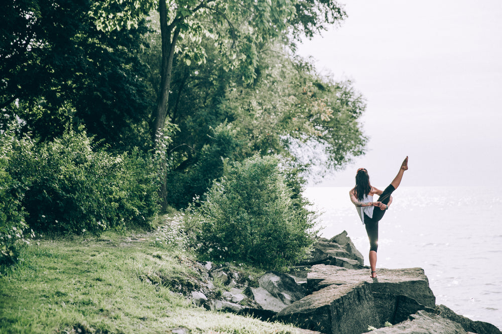 high leg reach around yoga pose balance