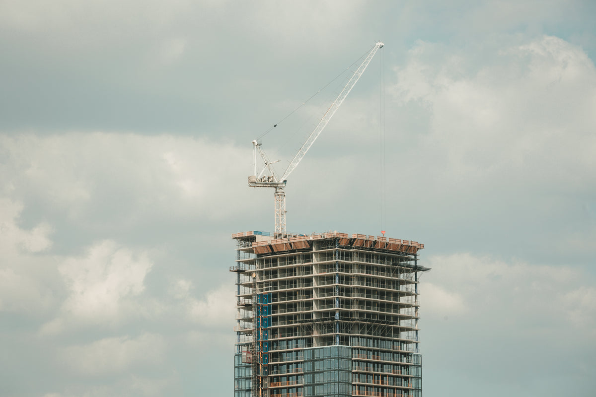 highrise construction glass building crane