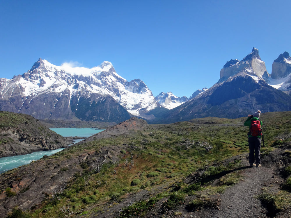 hiker near snow capped mountain