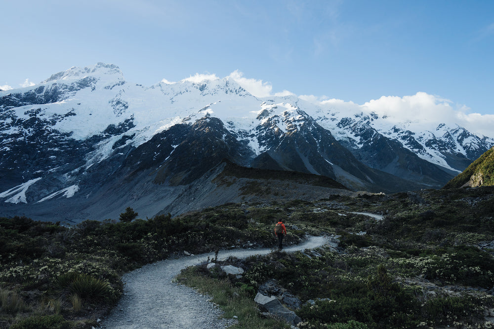 hiker on rugged trail on mountain