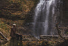 hiker relaxes by waterfall