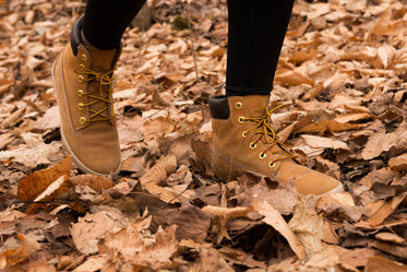hiker steping on leaves as they walk through