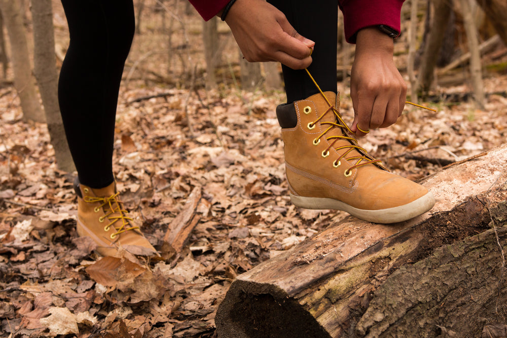 hiker ties their shoe