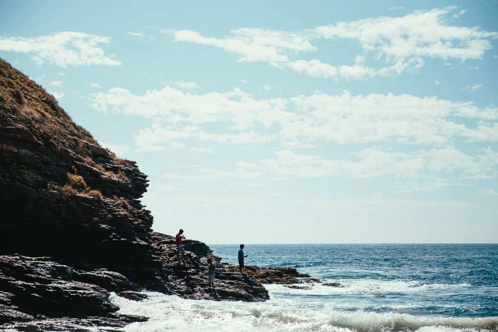 hikers on seaside rocks