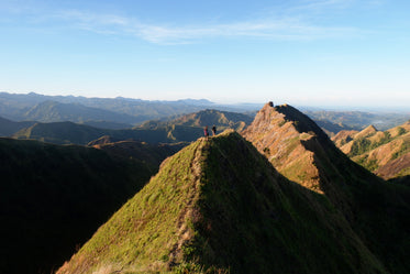 hikers walk along mountain peak