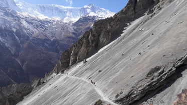 hikers walking across mountain trail