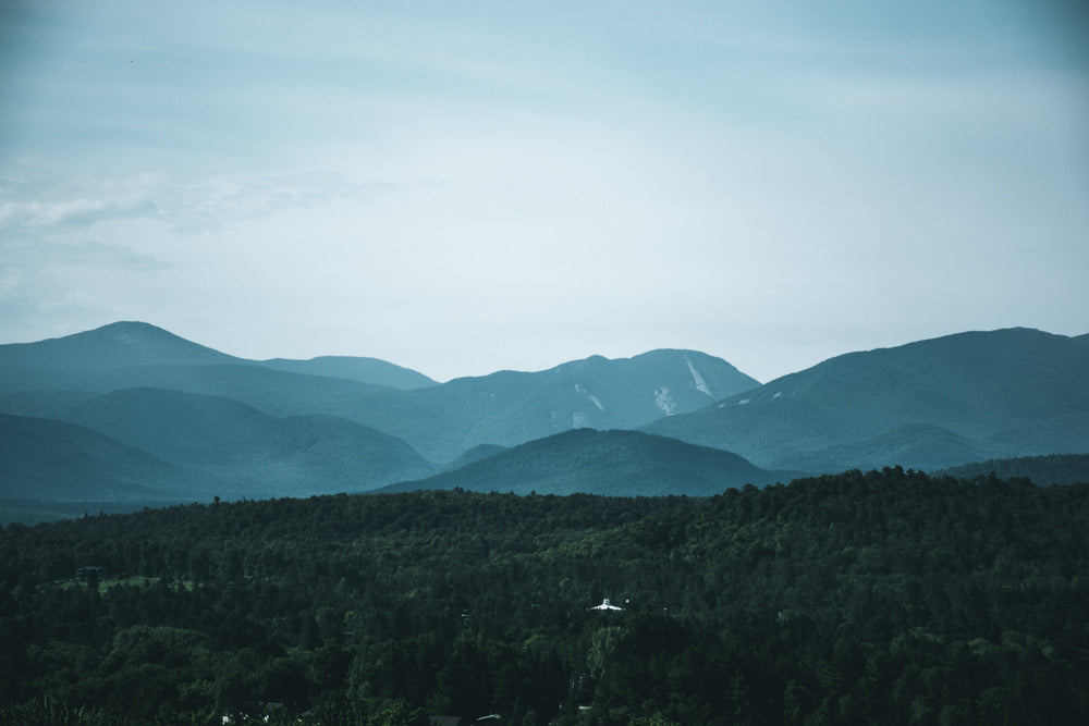 hills against a blue sky and a small white building