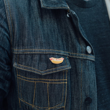 hotdog enamel pin on denim