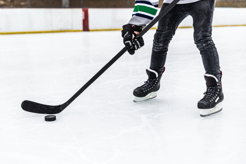 hockey player handling puck