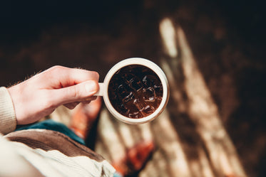 holding cup of iced coffee