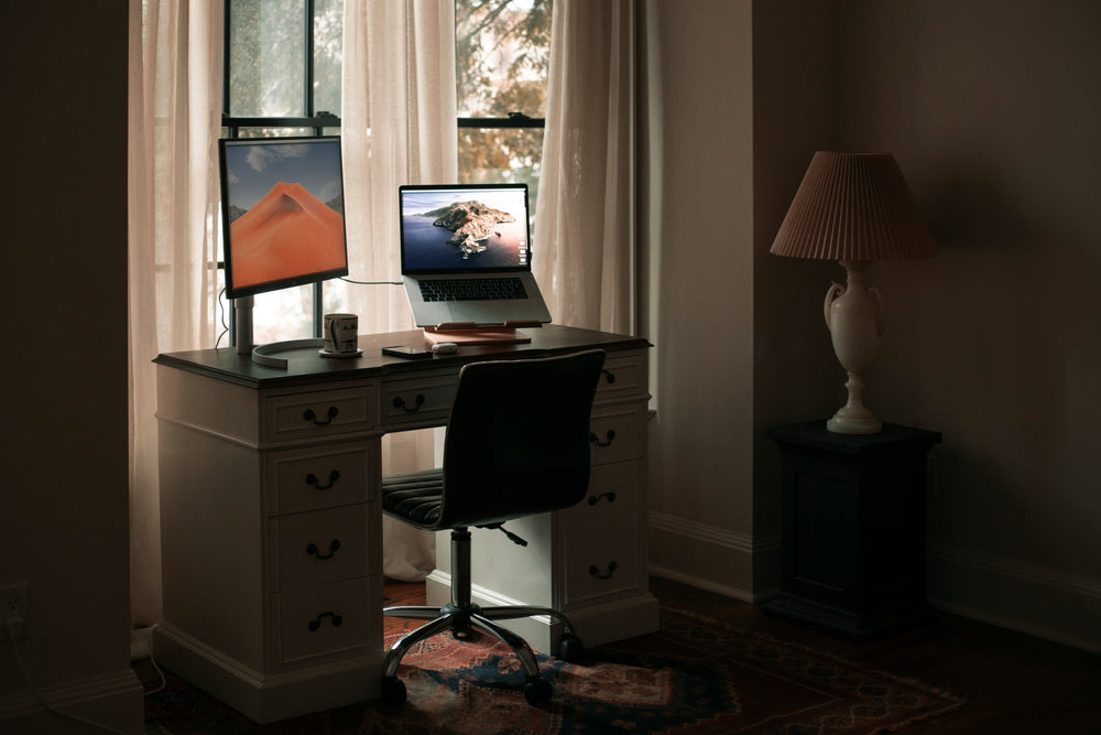 home office by a window with white curtains