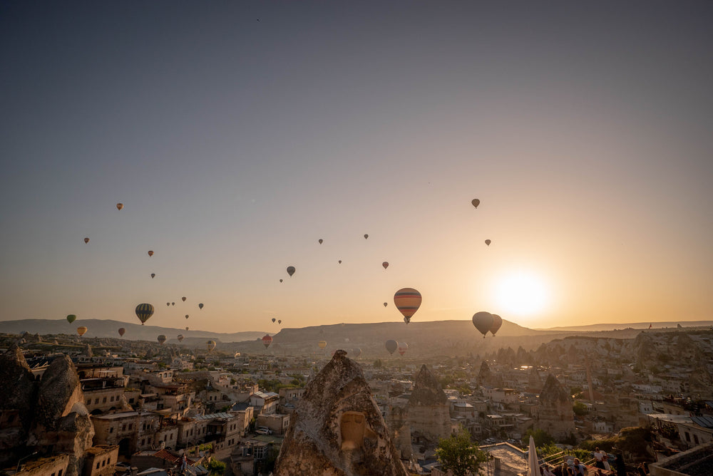 hot air balloons across horizon