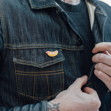 man unbuttoning jean jacket