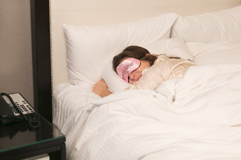a woman sleeping in bed - hotel sleep in