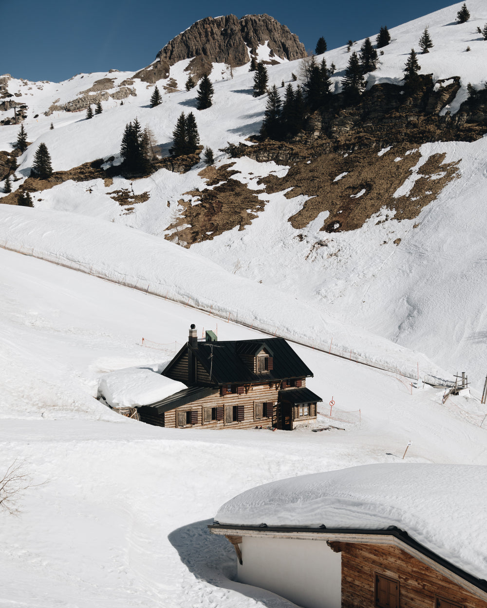 house at the foot of snowy mountain