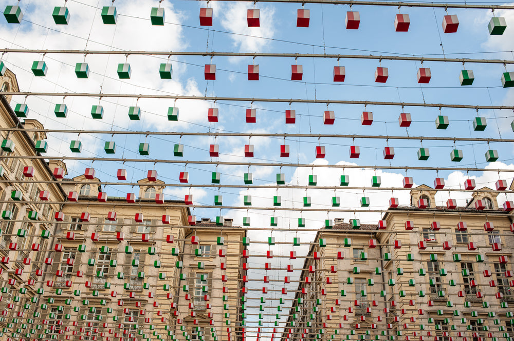 hundreds of red and green lanterns hanging over street