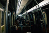 interior of a dark transit vehicle with people nearby