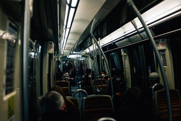 interior of a dark transit vehicle with people nearby