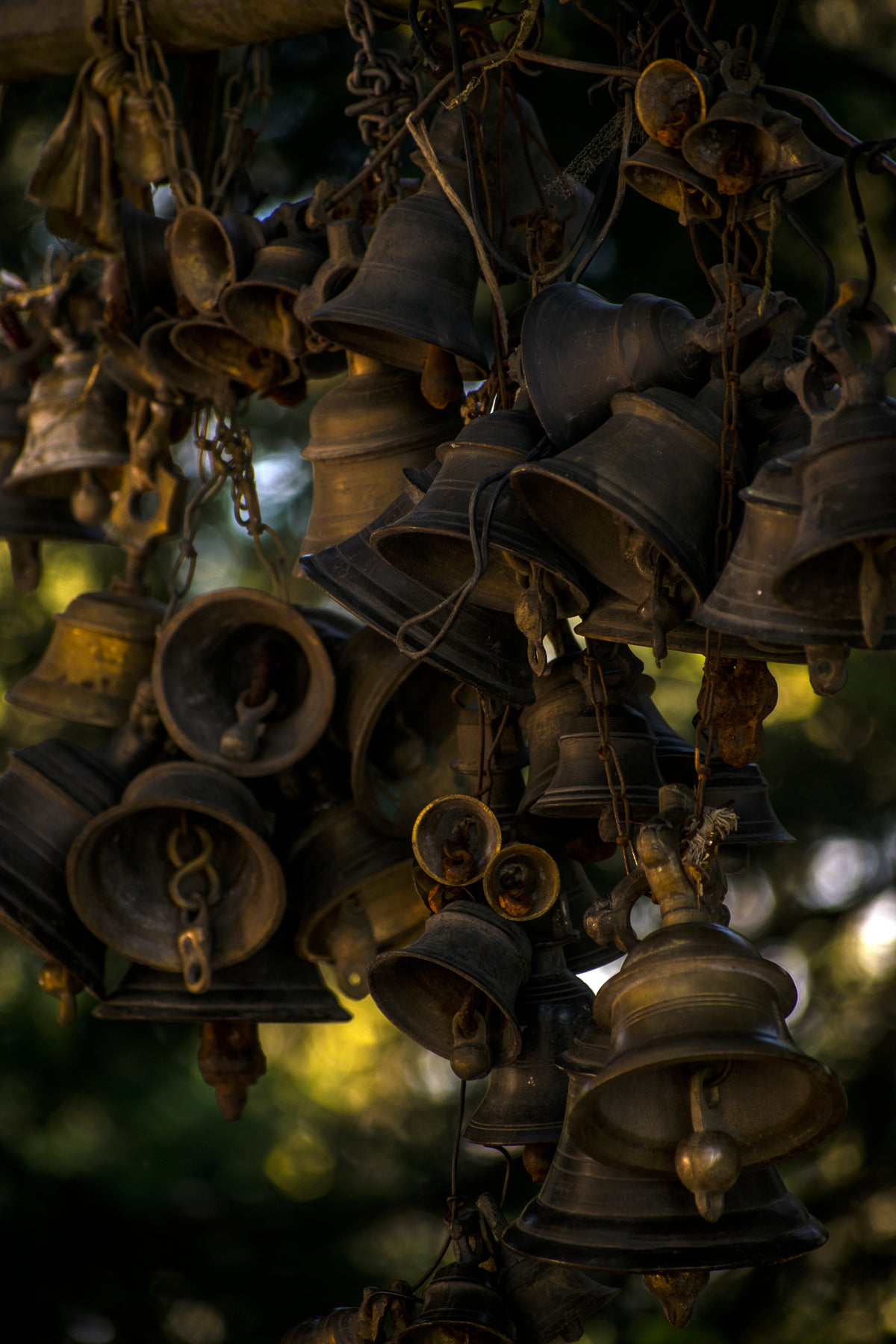 iron bells strung up in a bunch
