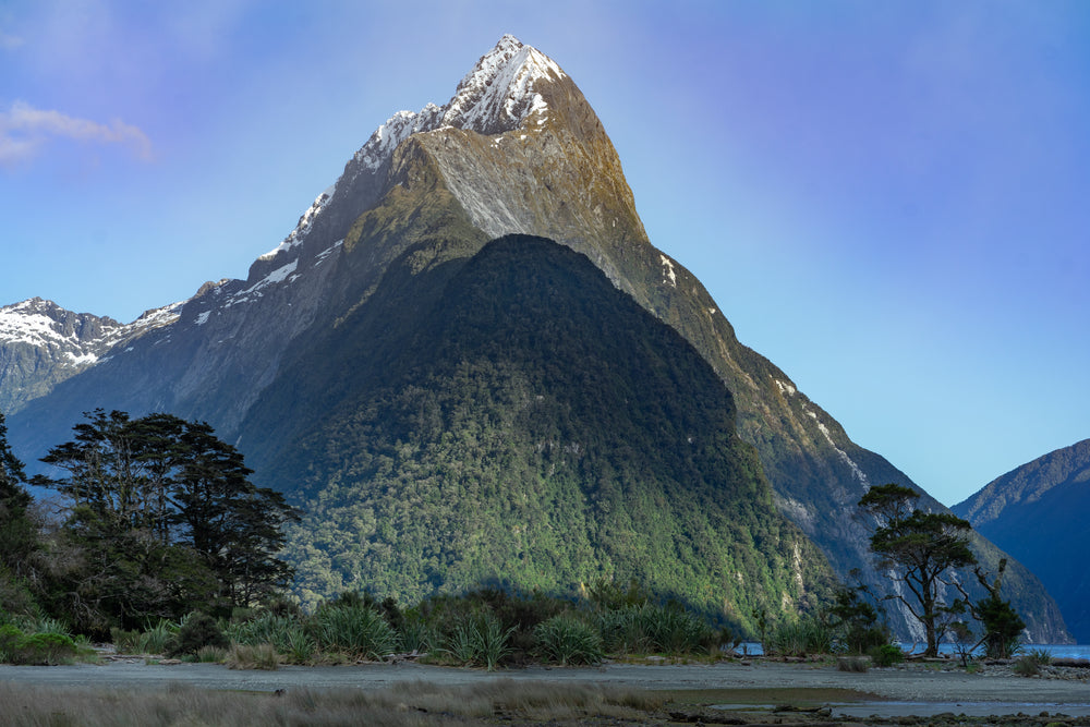 jagged mountain peak above lush green foothills