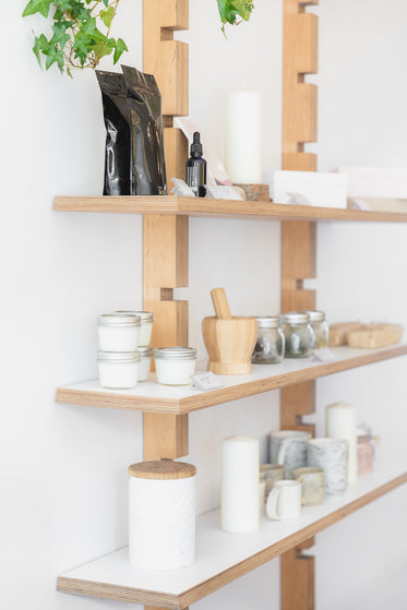 jars, candles and ceramics on wooden shelves