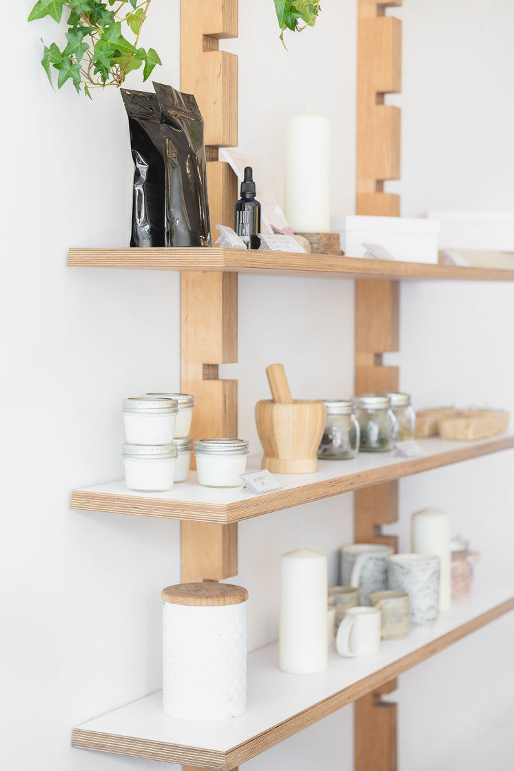 Jars, Candles And Ceramics On Wooden Shelves