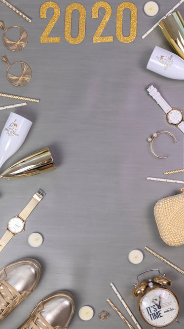 jewellery, champagne flutes, a clock and the numbers 2020