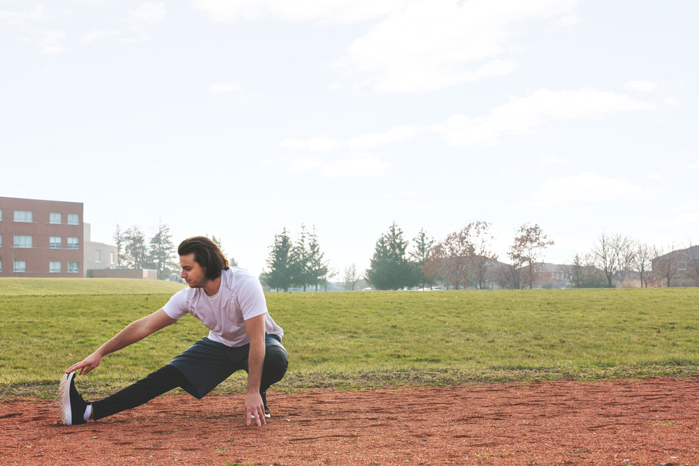 jogger stretching at track