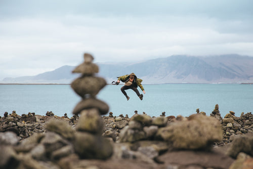 jumping action shot on rocky beach