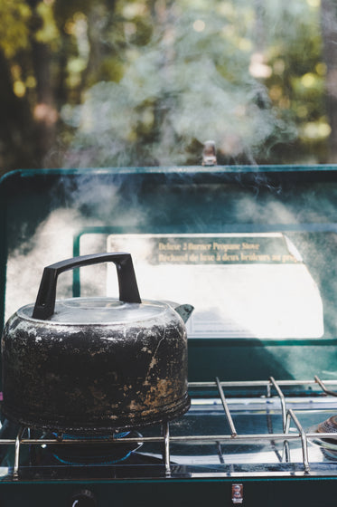 kettle steaming on camping stove