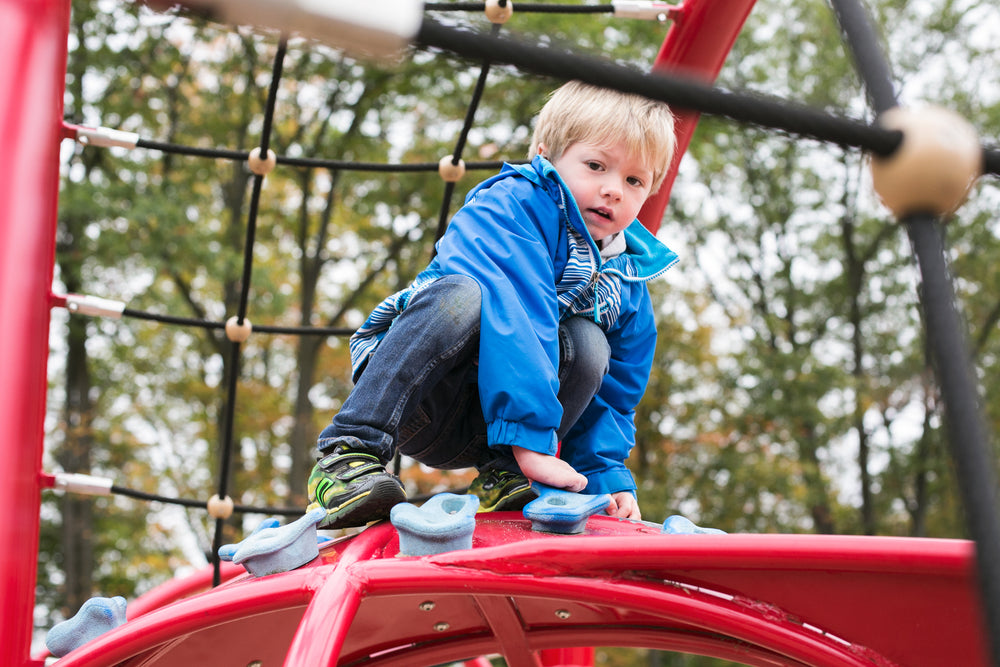 kid boy on climbing structure