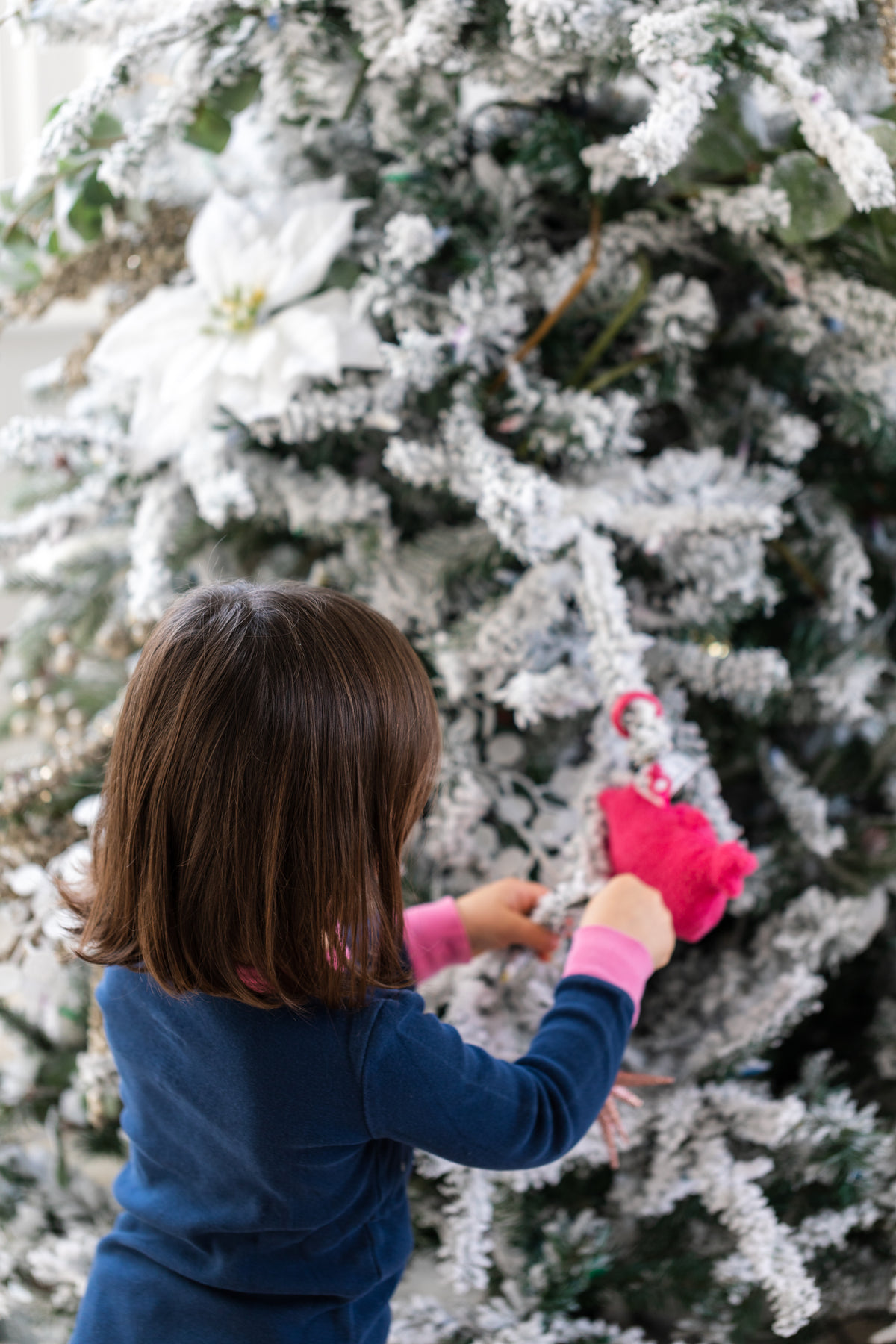 kid decorates tree