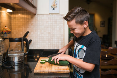 kid helping in kitchen