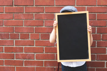 kid with blank chalkboard