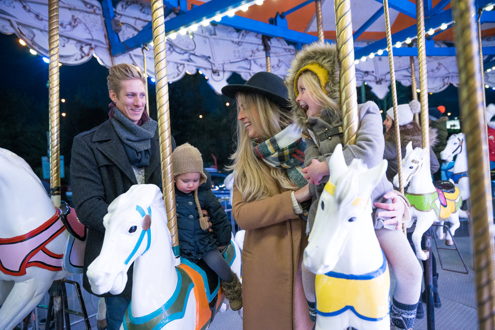 kids and parents on carousel horses