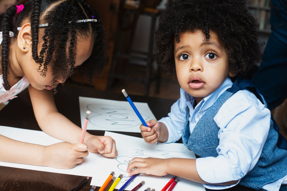 kids coloring at table