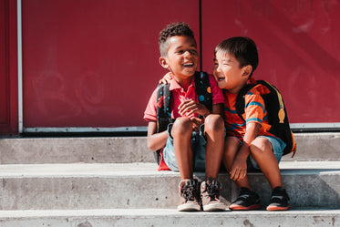 kids giggle on steps